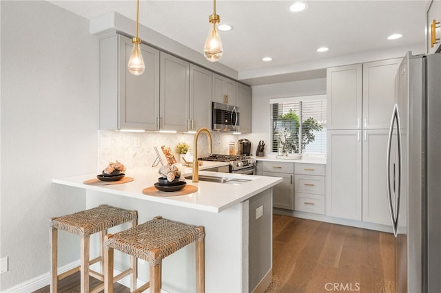 29416 Port Royal Way, Laguna Niguel, CA 92677 - kitchen with appliances with stainless steel finishes, a peninsula, wood finished floors, backsplash, and recessed lighting