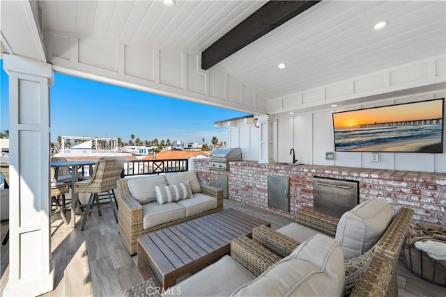 view of patio / terrace with an outdoor kitchen, outdoor lounge area, a sink, and area for grilling