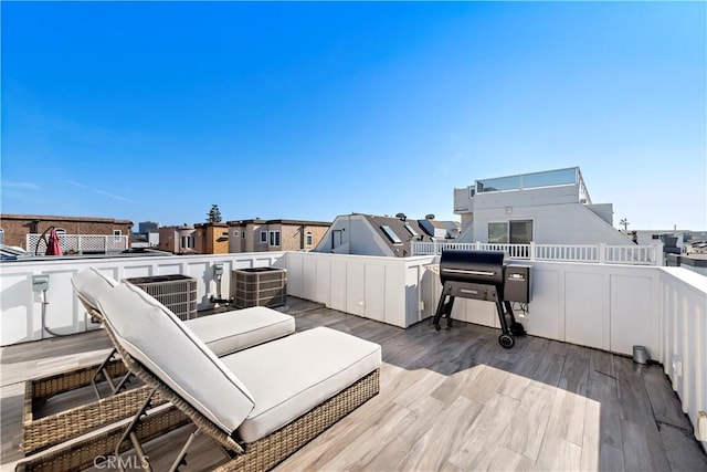 wooden terrace featuring a grill