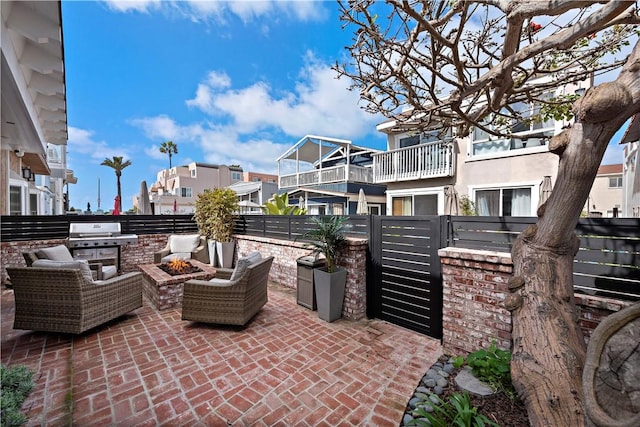 view of patio featuring a fire pit, a residential view, and fence