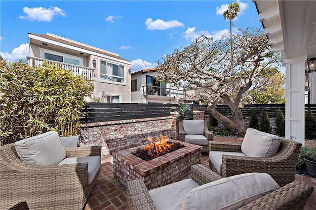 view of patio featuring fence and an outdoor living space with a fire pit