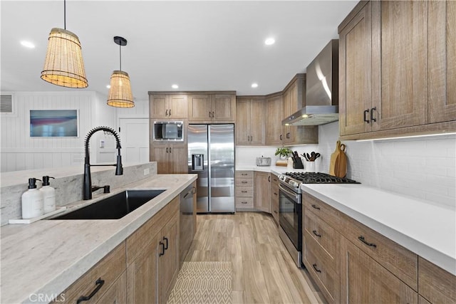 725 Dover Ct, San Diego, CA 92109 - kitchen featuring light wood finished floors, a sink, wall chimney exhaust hood, stainless steel appliances, and tasteful backsplash