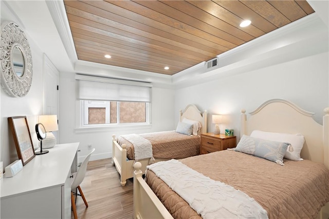 bedroom with wood ceiling, a raised ceiling, visible vents, and light wood finished floors