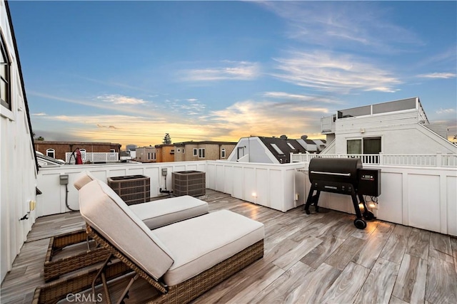 wooden deck with a grill and central AC