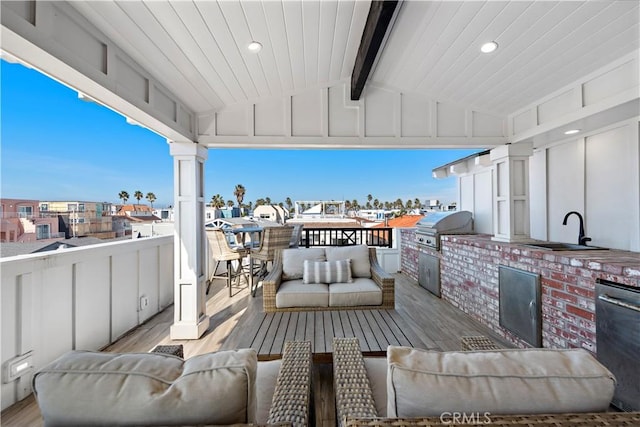 view of patio with exterior kitchen, a grill, outdoor lounge area, and a sink