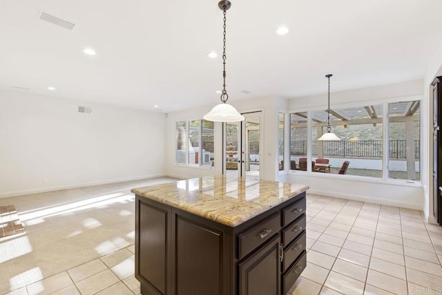 kitchen featuring light tile patterned floors, recessed lighting, dark brown cabinetry, and light colored carpet