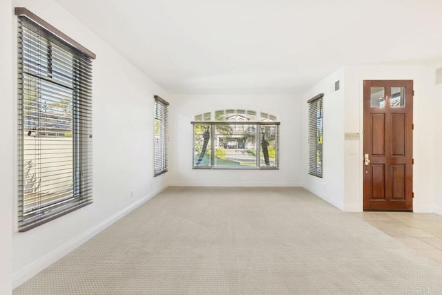 entryway with light carpet and baseboards