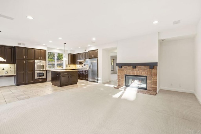 unfurnished living room featuring light carpet, a fireplace, and recessed lighting