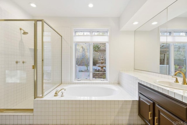 full bathroom featuring recessed lighting, a garden tub, a shower stall, and vanity