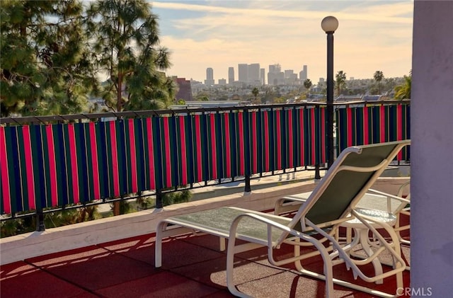 patio terrace at dusk with a view of city