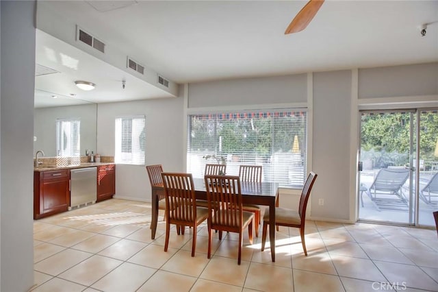 dining room with a ceiling fan, visible vents, and light tile patterned floors