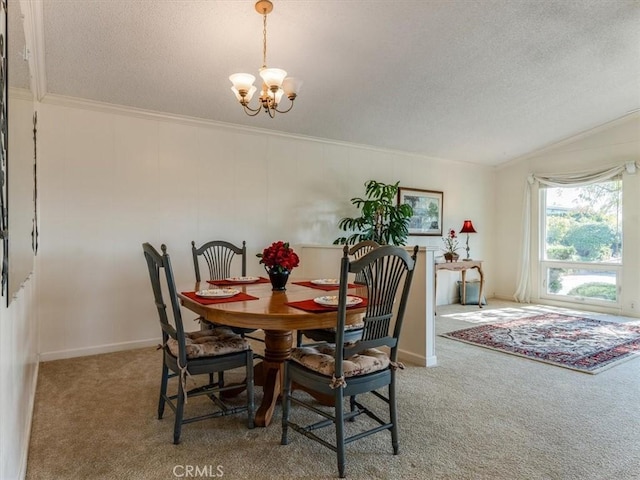 carpeted dining room featuring a chandelier, vaulted ceiling, a textured ceiling, and ornamental molding