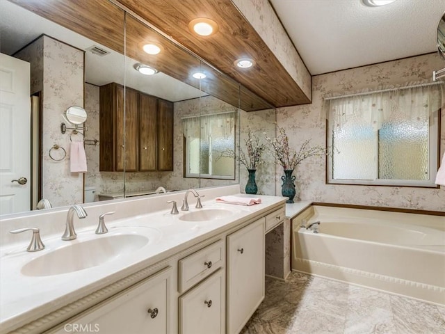 full bath with wallpapered walls, visible vents, a garden tub, and a sink