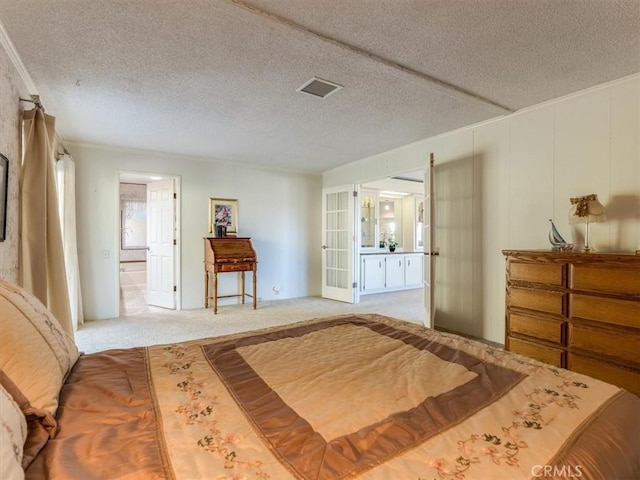 carpeted bedroom featuring french doors, visible vents, ornamental molding, connected bathroom, and a textured ceiling