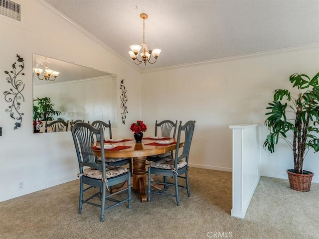 dining space with visible vents, ornamental molding, an inviting chandelier, vaulted ceiling, and carpet floors