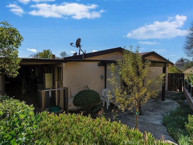 view of side of property with a patio area and fence