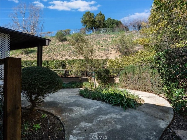 view of yard featuring fence and a patio