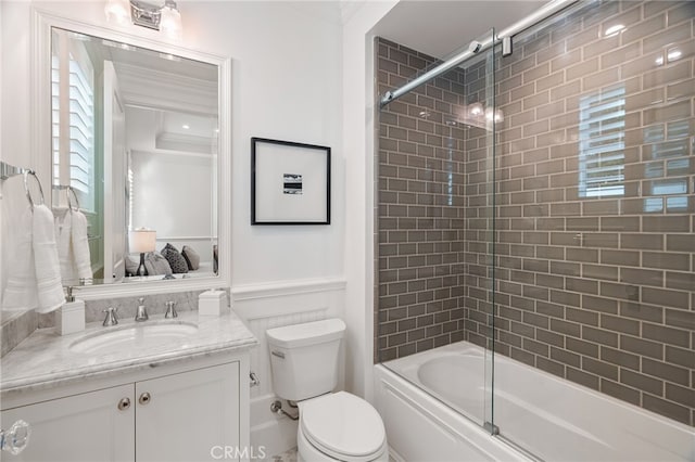 full bathroom featuring bath / shower combo with glass door, vanity, toilet, and crown molding