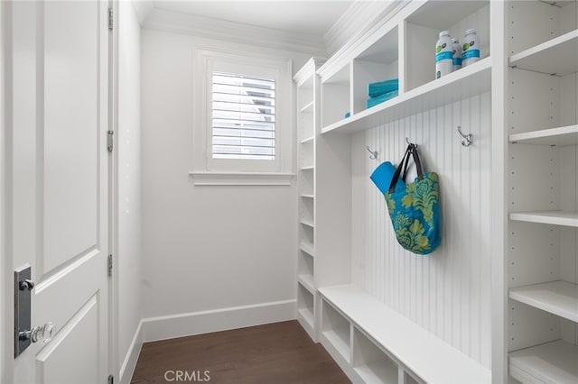 mudroom with crown molding, dark wood finished floors, and baseboards