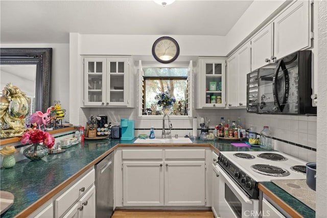 kitchen featuring white electric stove, decorative backsplash, dishwasher, black microwave, and a sink