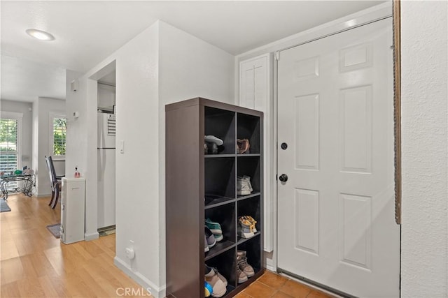 interior space featuring light wood-type flooring and baseboards