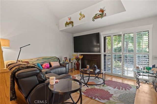 living room with vaulted ceiling and wood finished floors