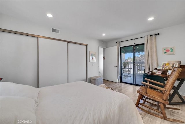 bedroom featuring access to outside, wood finished floors, visible vents, and recessed lighting