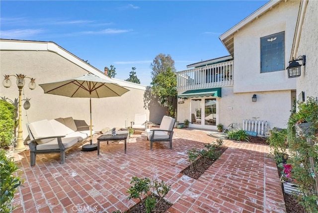 view of patio / terrace with french doors and an outdoor living space