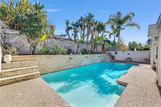 pool featuring a fenced backyard and a patio