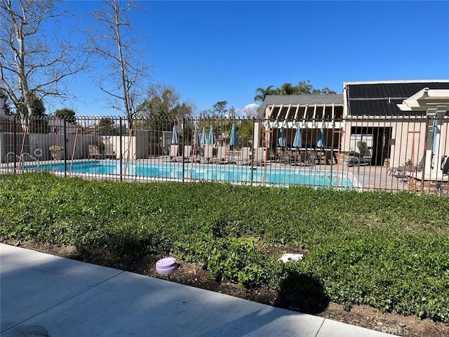 pool featuring fence and a patio