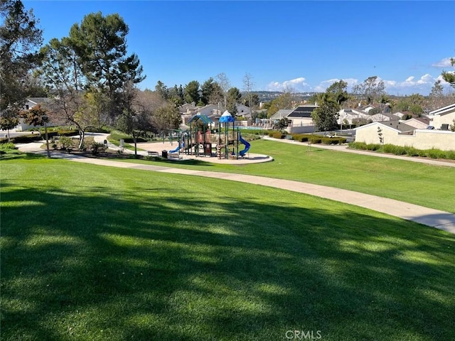 community play area featuring a lawn