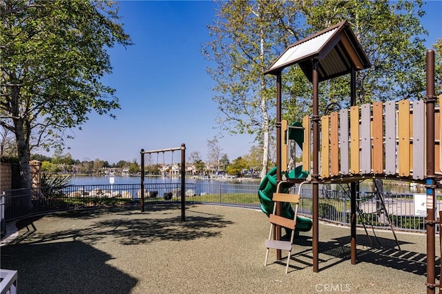 community play area with a water view and fence