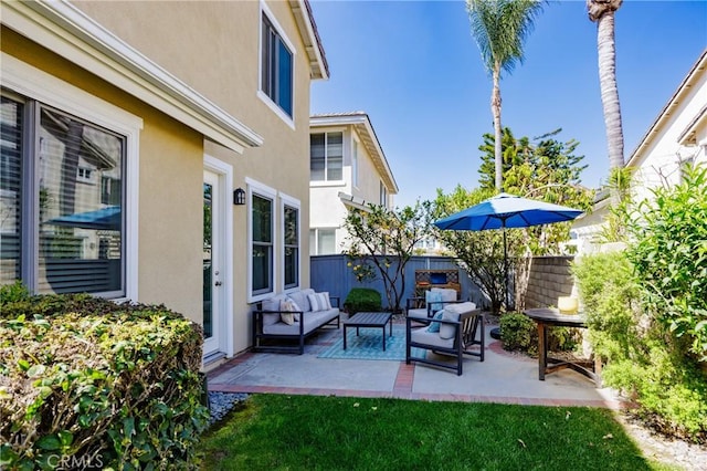 view of patio featuring fence and an outdoor hangout area