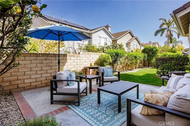 view of patio featuring a fenced backyard, a residential view, and an outdoor hangout area