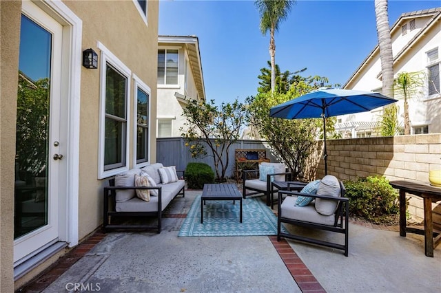 view of patio / terrace featuring an outdoor hangout area and fence