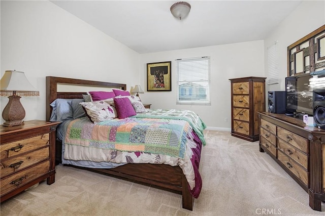 bedroom with baseboards and light carpet