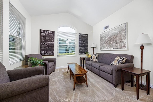 living room featuring baseboards, vaulted ceiling, and visible vents