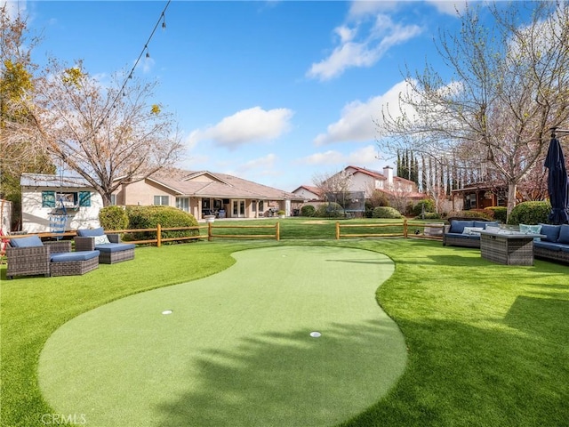 surrounding community with an outdoor hangout area, a yard, and fence