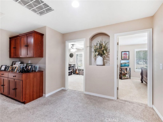 interior space featuring light carpet, baseboards, and visible vents