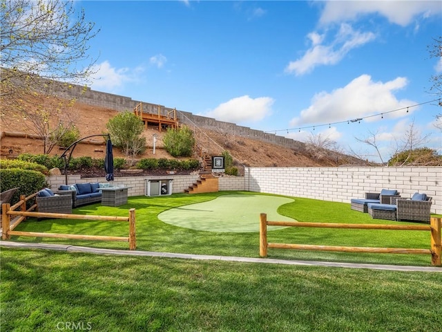 view of home's community featuring a lawn and outdoor lounge area