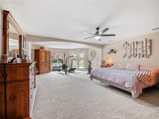 bedroom with access to outside, a textured ceiling, a ceiling fan, and carpet flooring