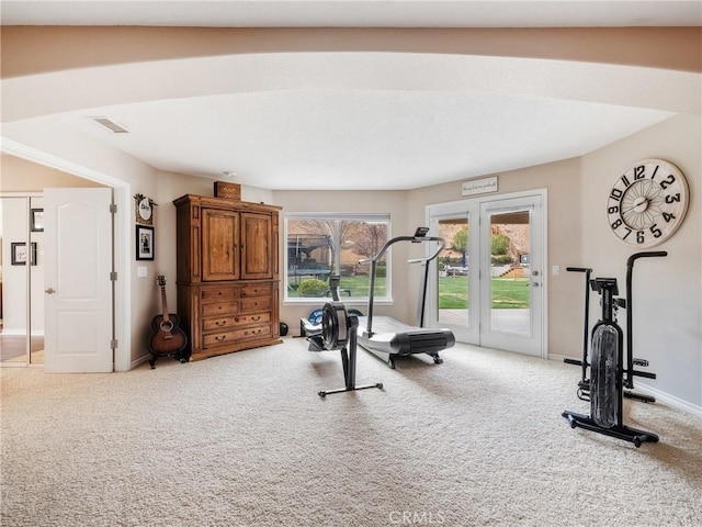 exercise room featuring carpet flooring and baseboards