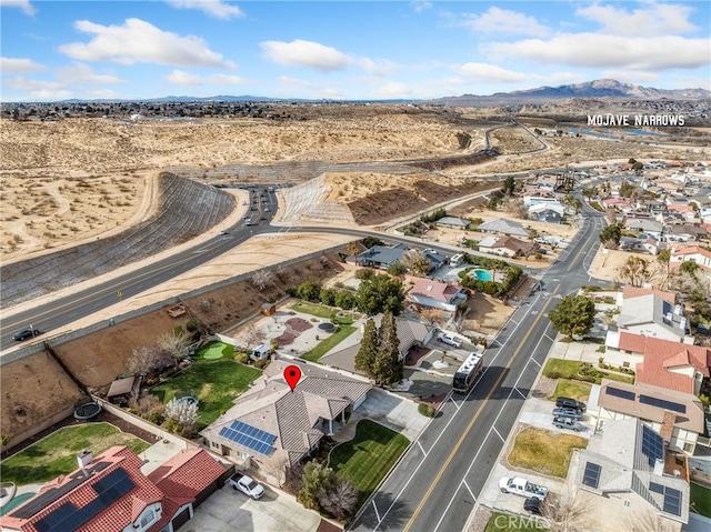 bird's eye view featuring a residential view, view of desert, and a mountain view