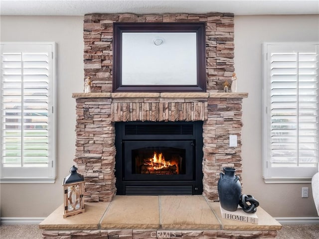 details featuring carpet flooring, a fireplace, and baseboards