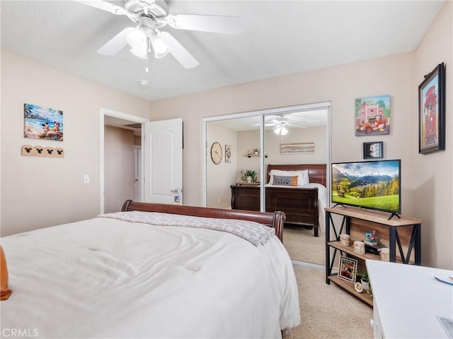 bedroom featuring a closet, light carpet, and ceiling fan