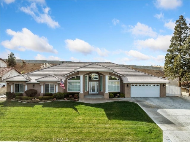 single story home with a garage, a tile roof, concrete driveway, stucco siding, and a front yard