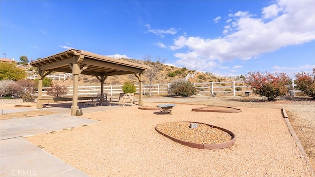 view of home's community with a gazebo, fence, and a patio