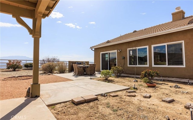 view of patio / terrace featuring fence and a mountain view