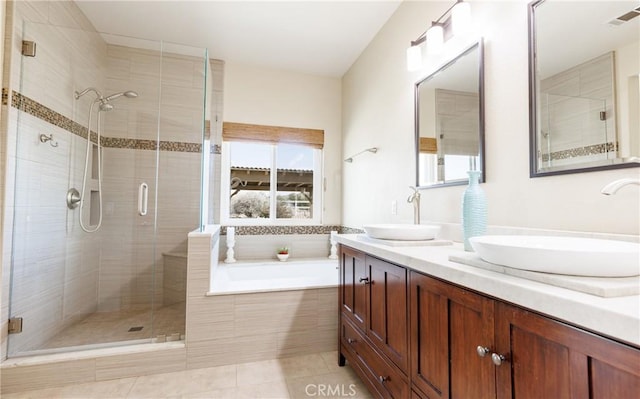 full bathroom featuring a stall shower, visible vents, and a sink