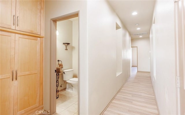 corridor featuring light wood-type flooring, recessed lighting, and visible vents